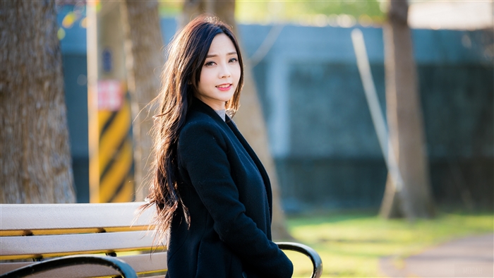 Smiling Woman with Long Brunette Hair in Black Coat