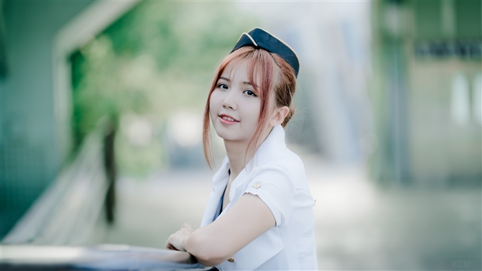 Young woman in a pilot hat and white uniform