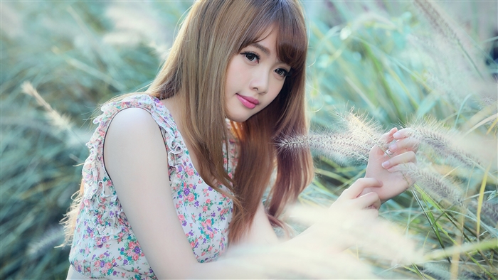 Cubie Wang in floral dress with grass