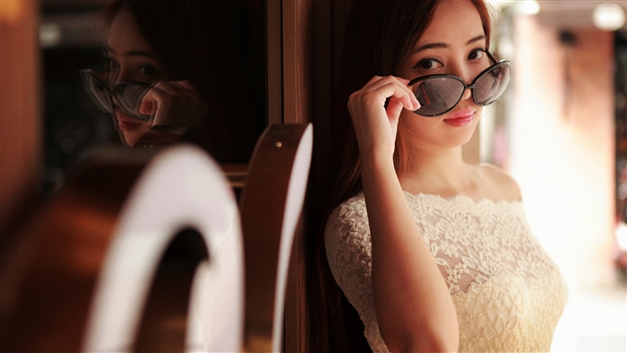 Asian girl wearing sunglasses and a lace dress