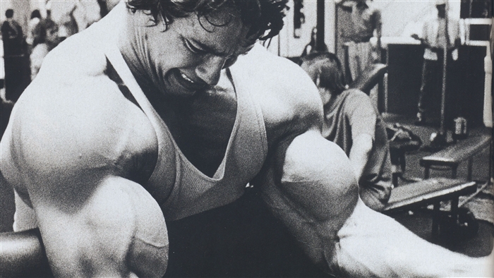 Arnold Schwarzenegger training in a gym