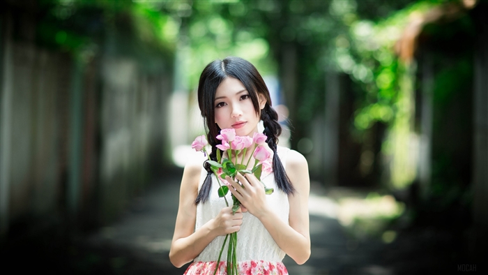 Young Asian Girl Holding Pink Flowers in Nature
