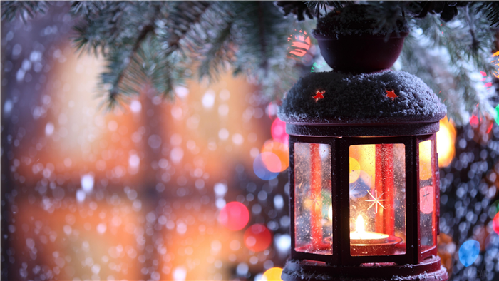 Christmas lantern with candle and snow