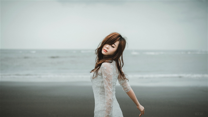 Woman in white dress on a beach
