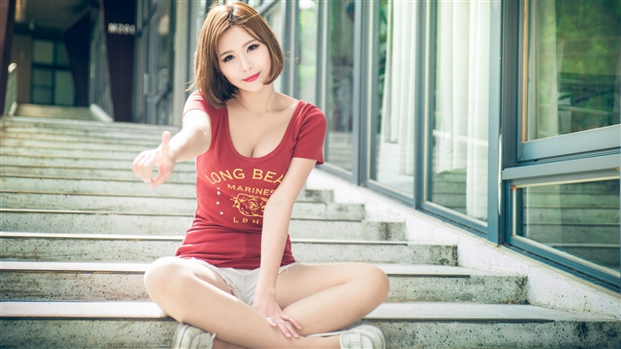 Woman in red shirt sitting on stairs