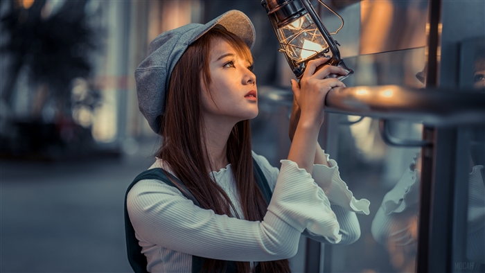Woman Holding Lantern in Warm Light 4K