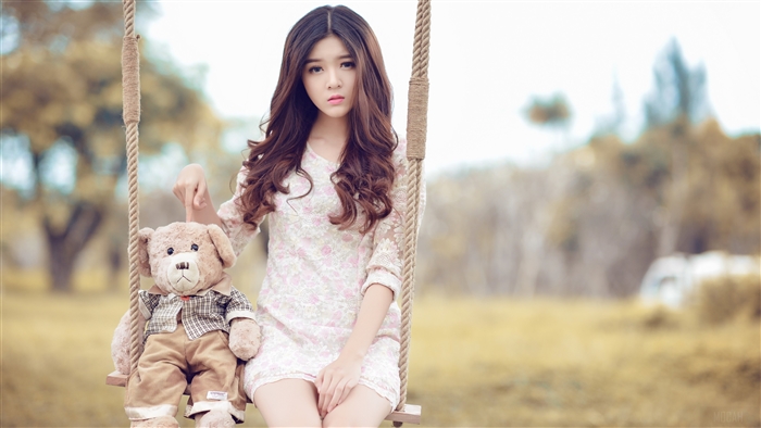 Woman with Teddy Bear on a Swing