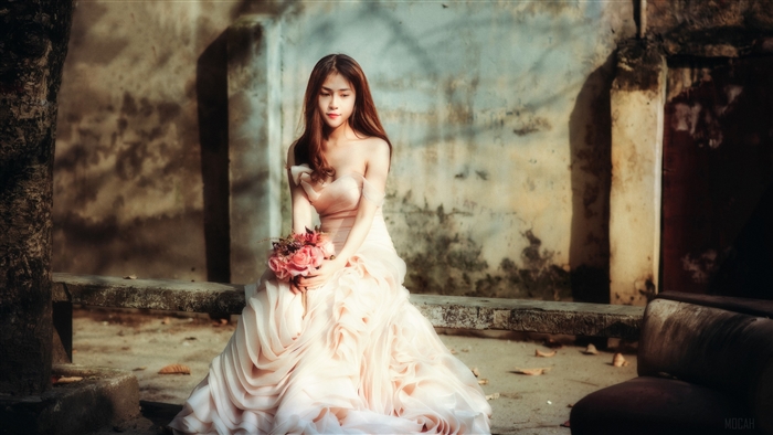 Woman in a pink dress holding flowers