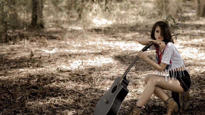 Asian woman with guitar in forest 4K