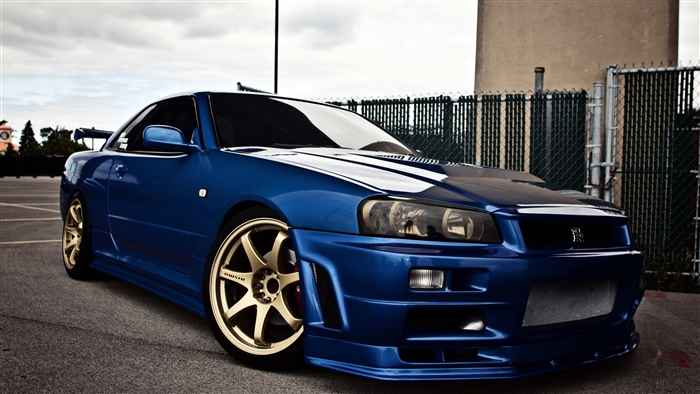Blue Nissan Skyline R34 GT-R with gold rims