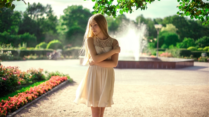 Young woman in a park with a fountain