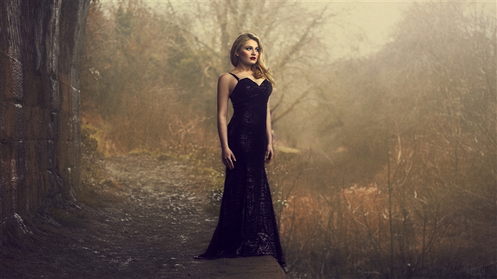 Woman in black dress in forest