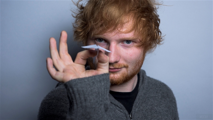 Ed Sheeran holding a paper airplane