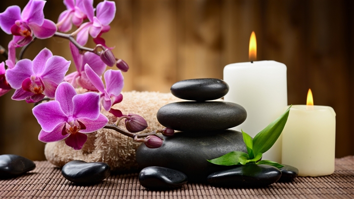 Spa scene with orchids, stones, and candles 4K