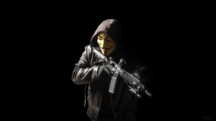 Man in Guy Fawkes mask holding assault rifle