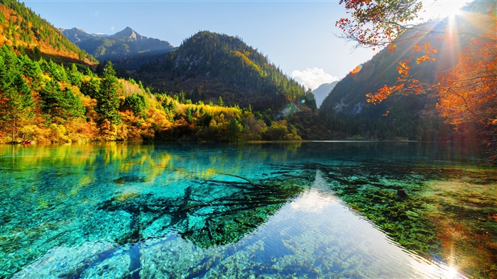 Autumn lake with mountains and sunbeams