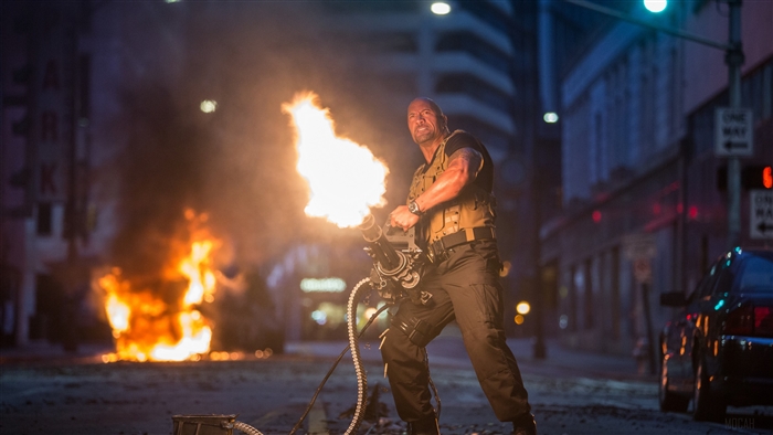 Luke Hobbs from Fast and Furious firing a minigun