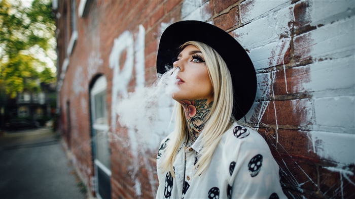 Woman with tattoos wearing a hat and smoking 4K