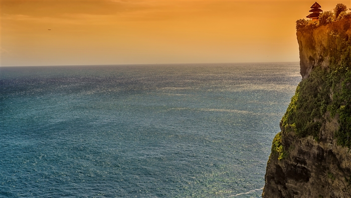 Temple on a cliff overlooking the ocean at sunset in Bali, Indonesia 4K