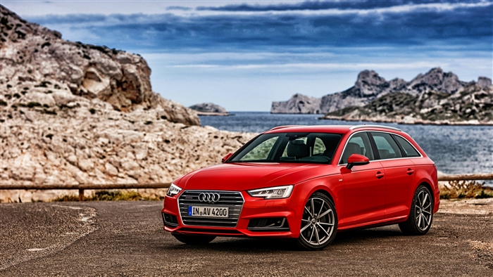 Red Audi A4 Avant parked by the sea