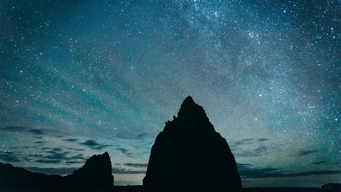 Starry Night Sky Over Rocky Silhouettes