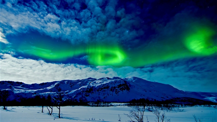 Aurora Borealis over snow-covered mountains