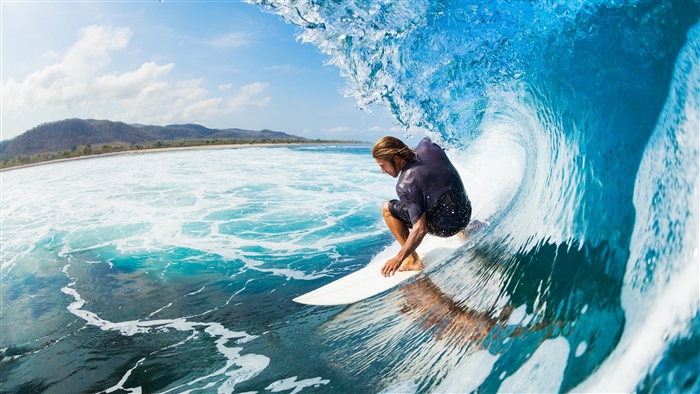 Surfer riding a wave in the ocean