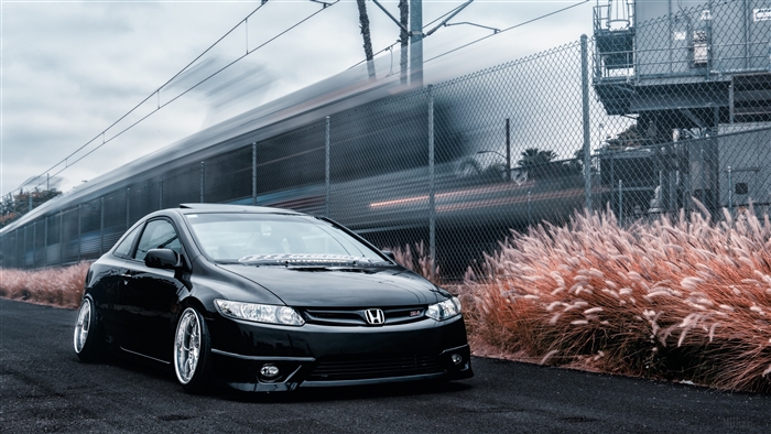 Black Honda Civic Coupe with Train in Background