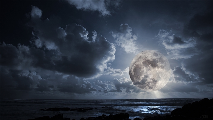 Full moon over the ocean at night