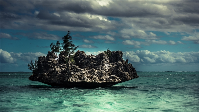 Rock formation in the ocean with clouds and waves 4K
