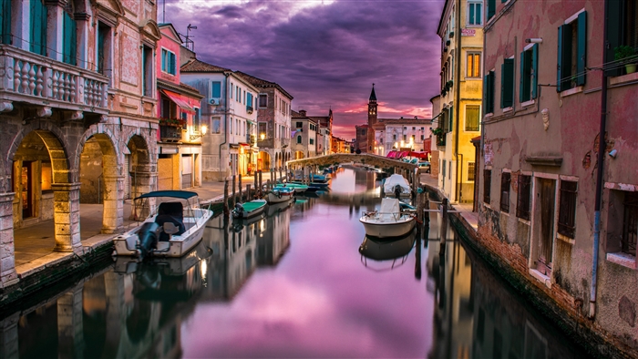 Boats on a canal in Chioggia at sunset 4K