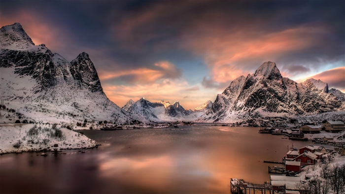 Snowy Mountains and Village at Sunset