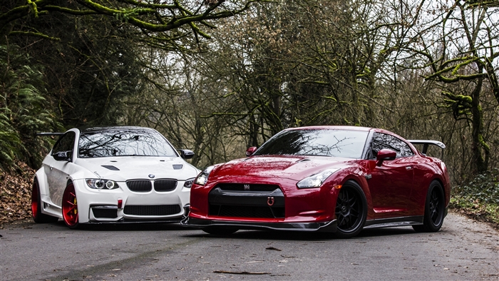 White BMW M3 and red Nissan GT-R parked on a road