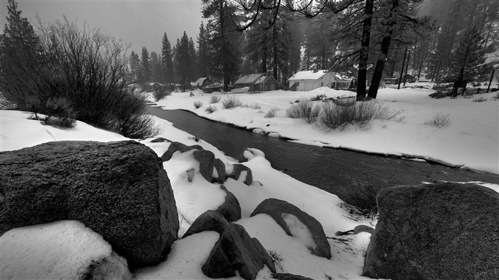 Winter scene with a stream and houses
