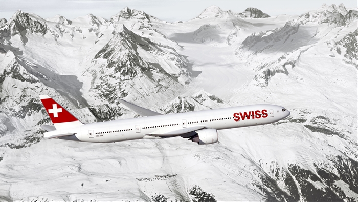 Swiss Airlines airplane flying over snowy Alps mountains 4K