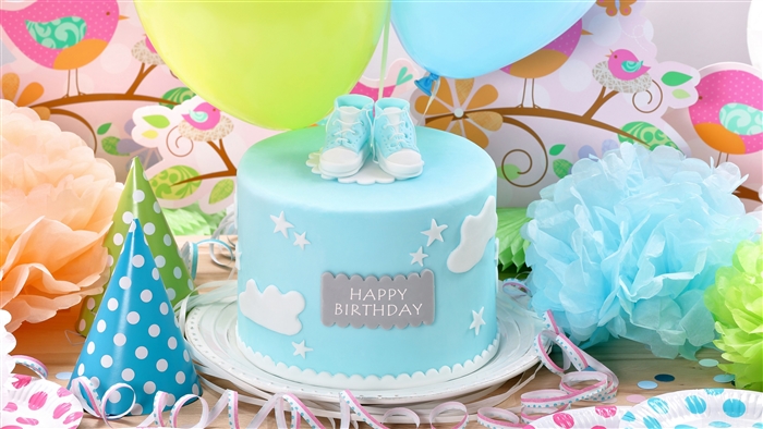 Blue Birthday Cake with Baby Shoes and Party Decorations