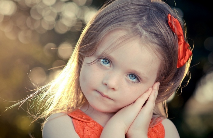 Girl with blue eyes and red bow