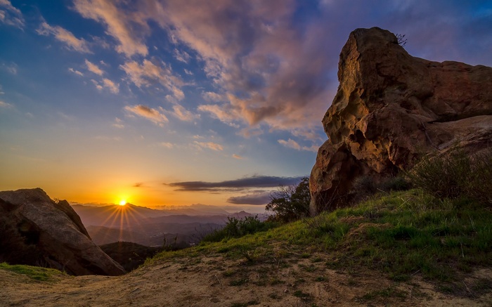 Sunset over mountains with rock formations