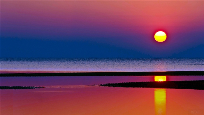 Sunset over the sea with reflection