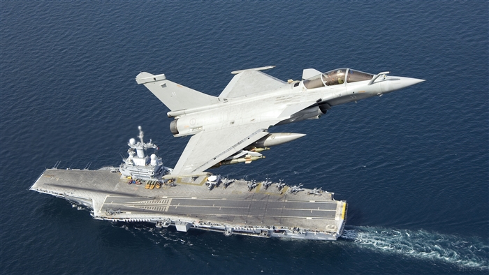 Fighter Jet Flies Over Aircraft Carrier