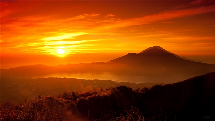 Sunset over a volcano and lake