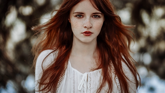 Redhead woman with freckles and red lipstick