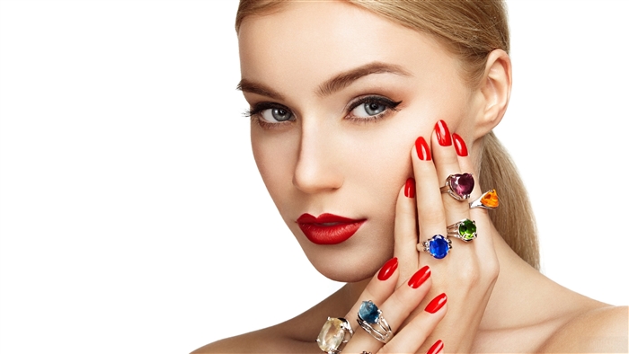 Woman with red nails and gemstone rings