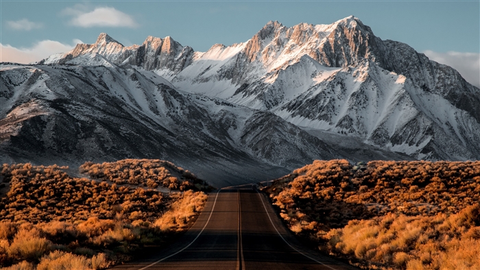 Road leading to snow-capped Sierra Nevada mountains