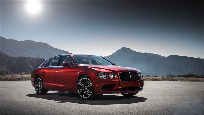 Red Bentley Flying Spur luxury car on asphalt road