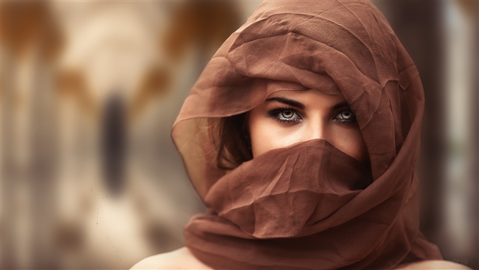 Woman with blue eyes wearing a brown headscarf