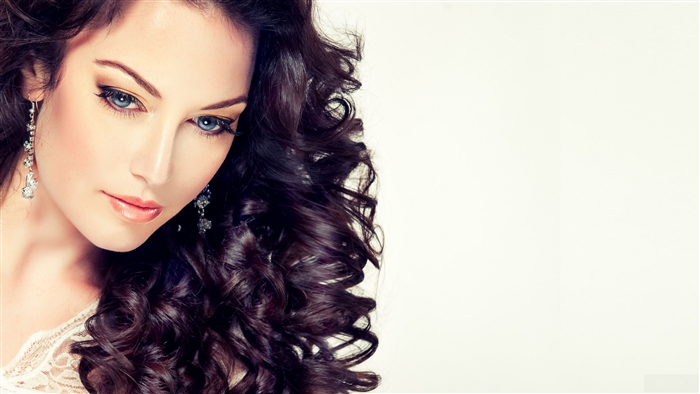 Model with Long Curly Hair and Earrings