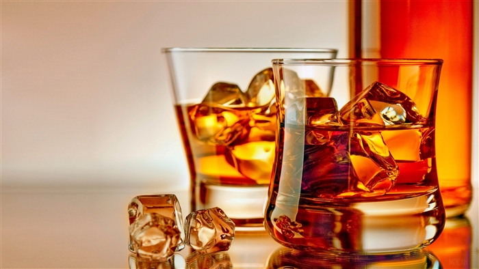 Whisky glasses with ice and bottle 4K