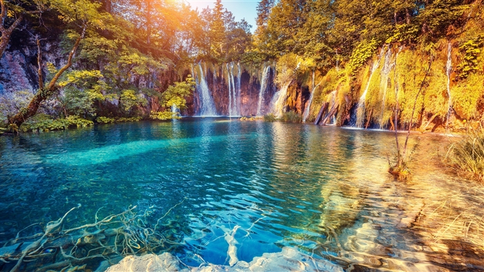 Waterfall and turquoise lake in nature 4K