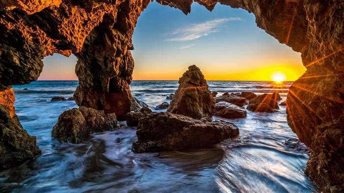 Sunrise Through Rocky Ocean Cave 4K